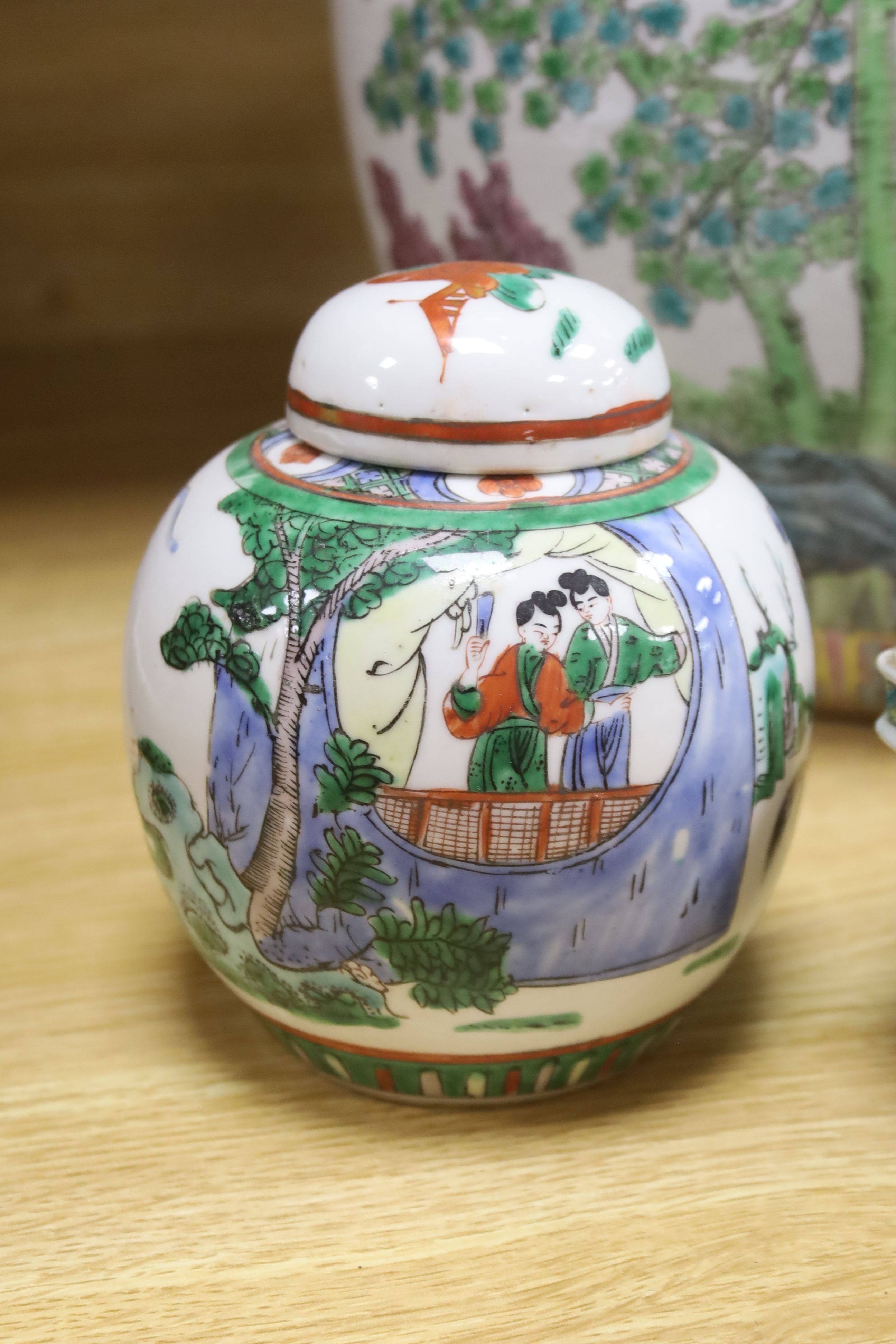 A Chinese famille rose jardiniere, a late 19th century famille rose narcissus pot, a cylindrical vase and a famille verte jar and cover, tallest 28.5cm